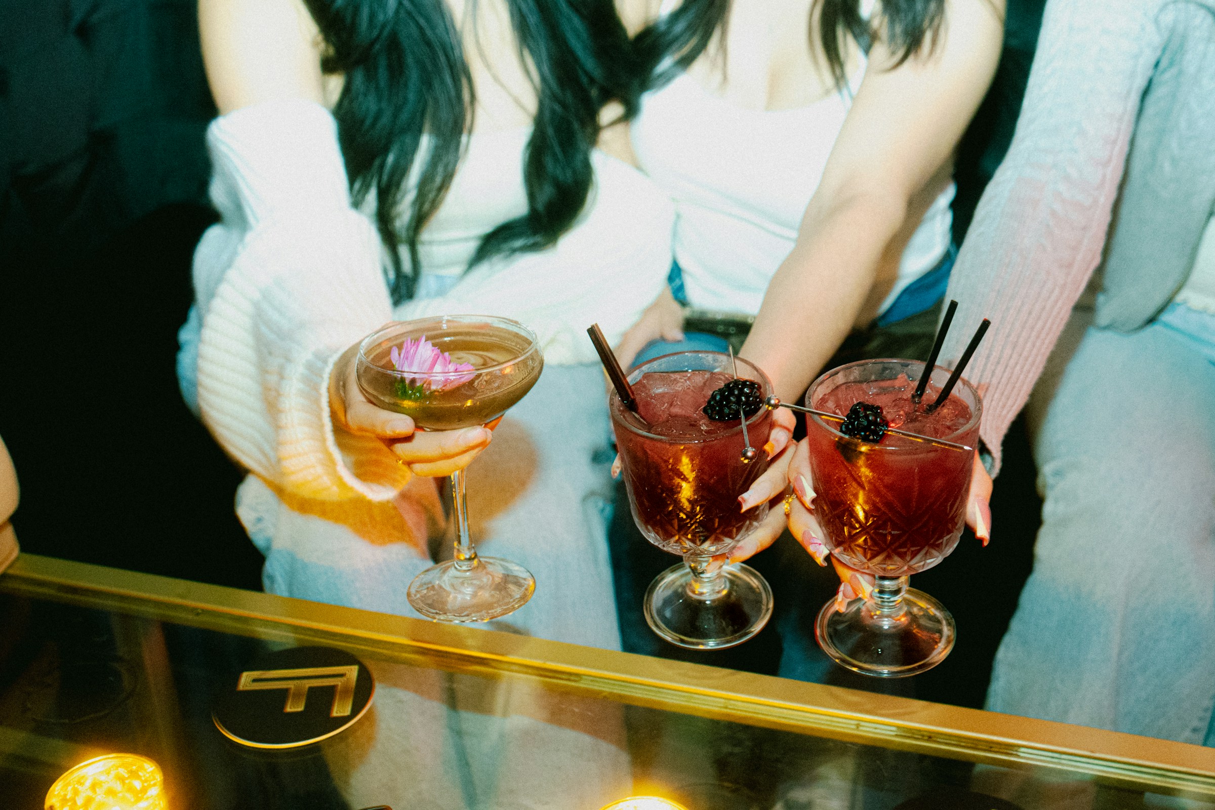 Photo by <a href="https://unsplash.com/@createasea?utm_content=creditCopyText&utm_medium=referral&utm_source=unsplash">Createasea</a> on <a href="https://unsplash.com/photos/friends-hold-cocktails-enjoying-a-night-out-cy6fbxVupbI?utm_content=creditCopyText&utm_medium=referral&utm_source=unsplash">Unsplash</a>